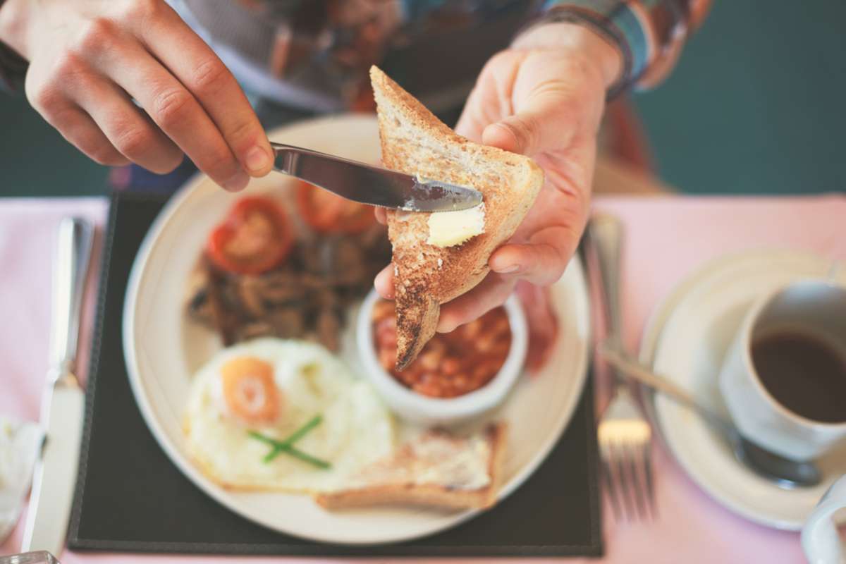 Closeup on a young womans hands as she is having breakfast