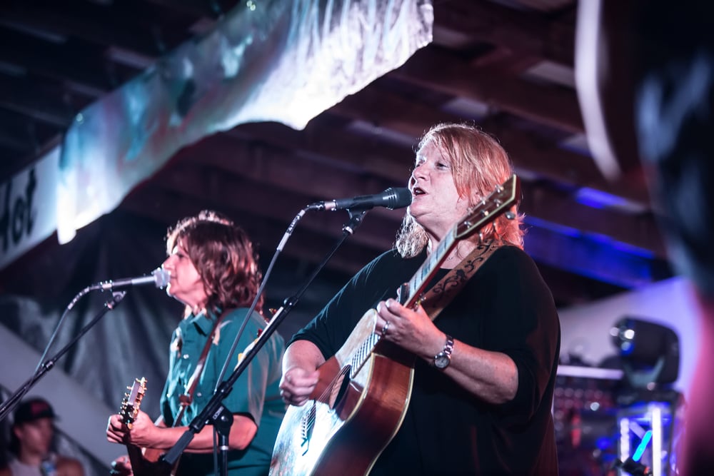 Indigo Girls duo Amy Ray and Emily Sailers singing on stage at Wild Goose Festival on July 9, 2016