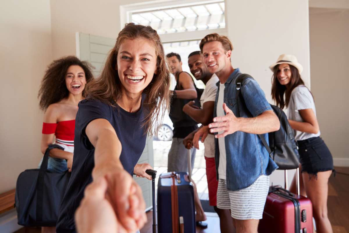 Point Of View Shot Of Friends Leaving Summer Vacation Rental